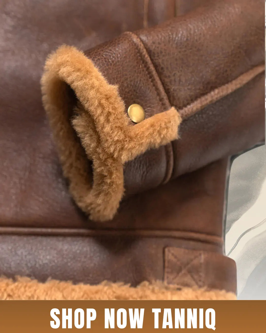 Brown bomber shearling leather jacket with real wool lining and button, featuring 'Shop Now Tanniq' text.