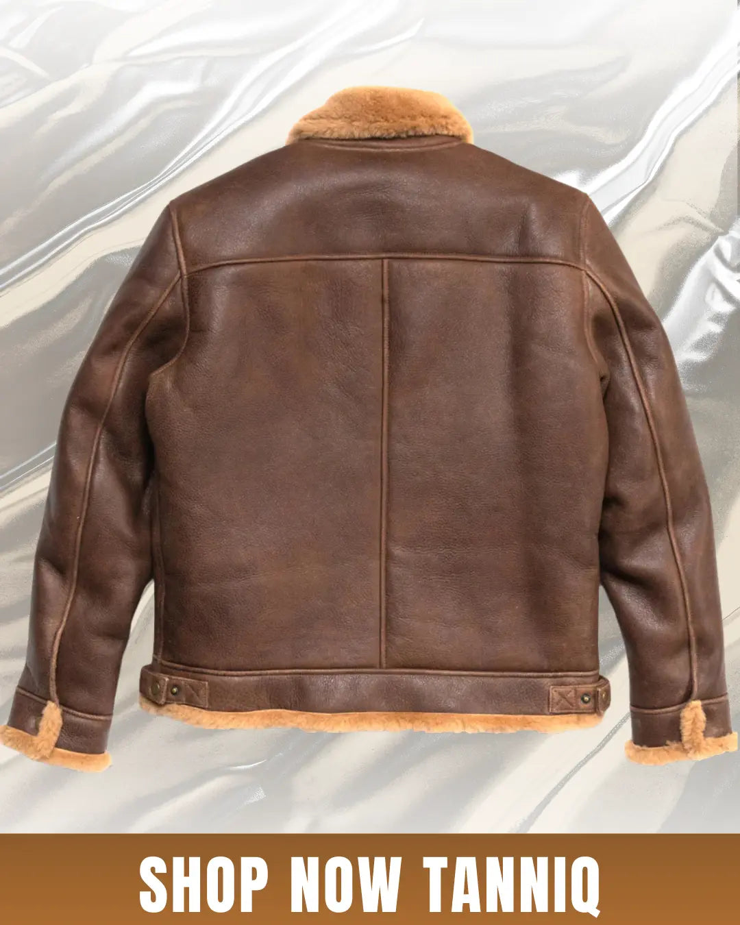 Brown shearling bomber jacket from back side in top of white background wth a text "SHOP NOW TANIQ"