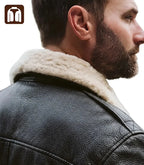 Close-up of a man wearing a black leather jacket with a white fur collar.
