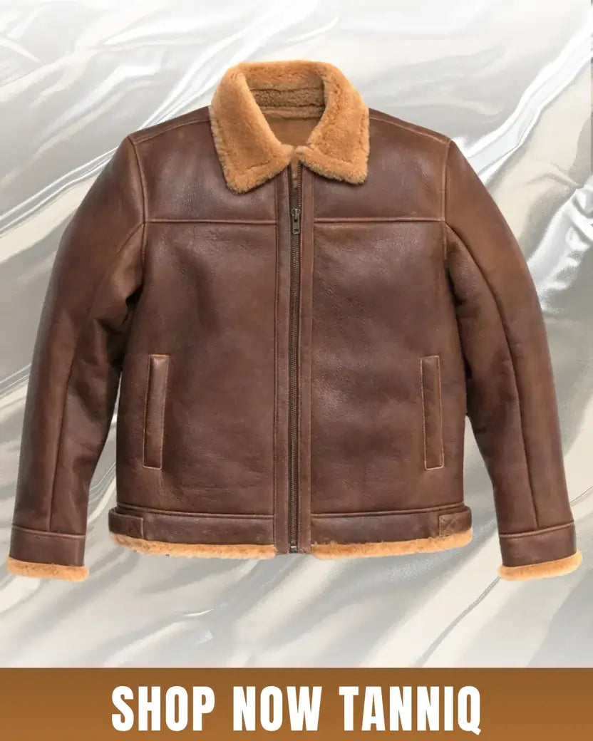 Brown leather jacket with fur collar on a light gray background
