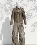 Mannequin wearing a brown jacket and cargo pants against a white background with leaf shadows.