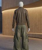 Mannequin wearing a brown jacket and green cargo pants in an indoor setting.