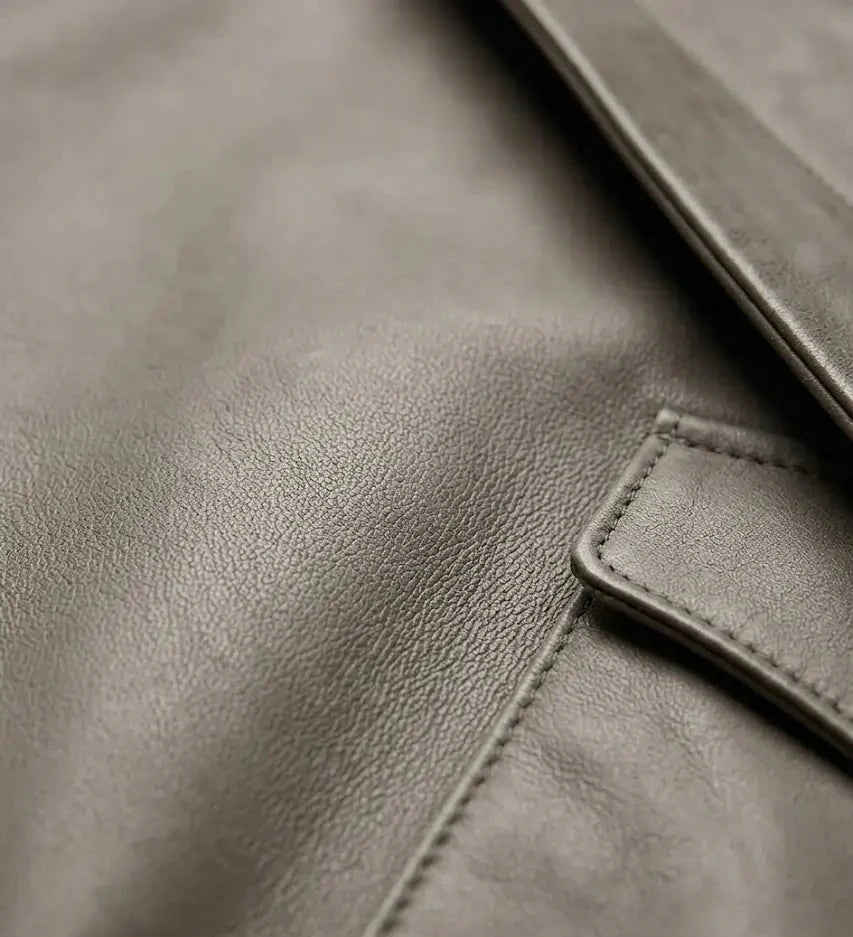 Close-up of a brown leather jacket with visible stitching