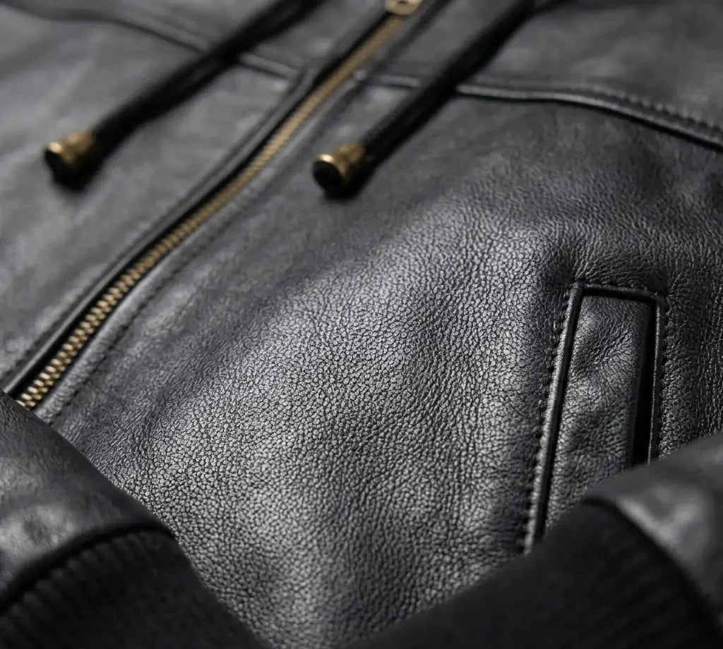 Close-up of a black leather jacket with zipper details