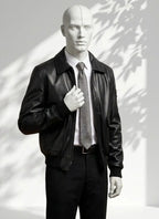 Mannequin wearing a black leather jacket and gray tie against a white background