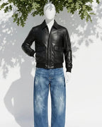 Mannequin wearing a black leather jacket and blue jeans with a white background and tree shadow.