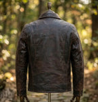Brown leather jacket on a mannequin against a blurred natural background