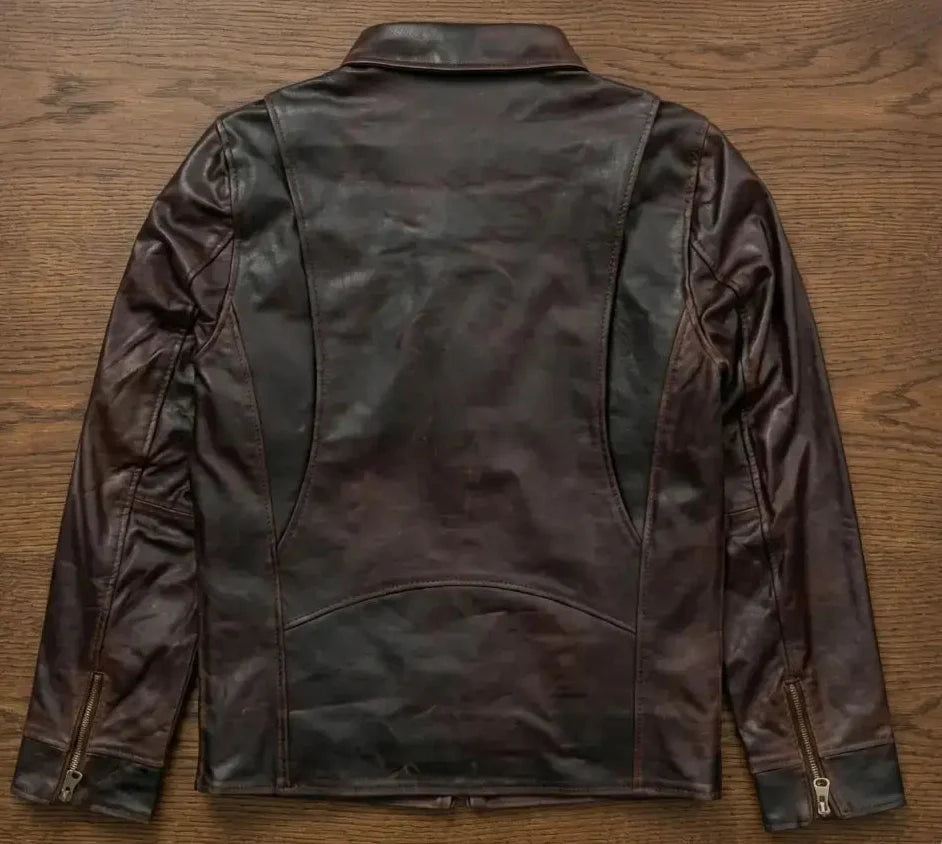 Brown leather jacket on a wooden surface