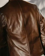 Close-up of a brown leather jacket with a blurred background