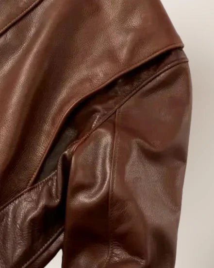 Close-up of a brown leather jacket on a white background